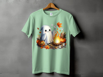 Light green t-shirt with a Halloween graphic of a ghost by a campfire.