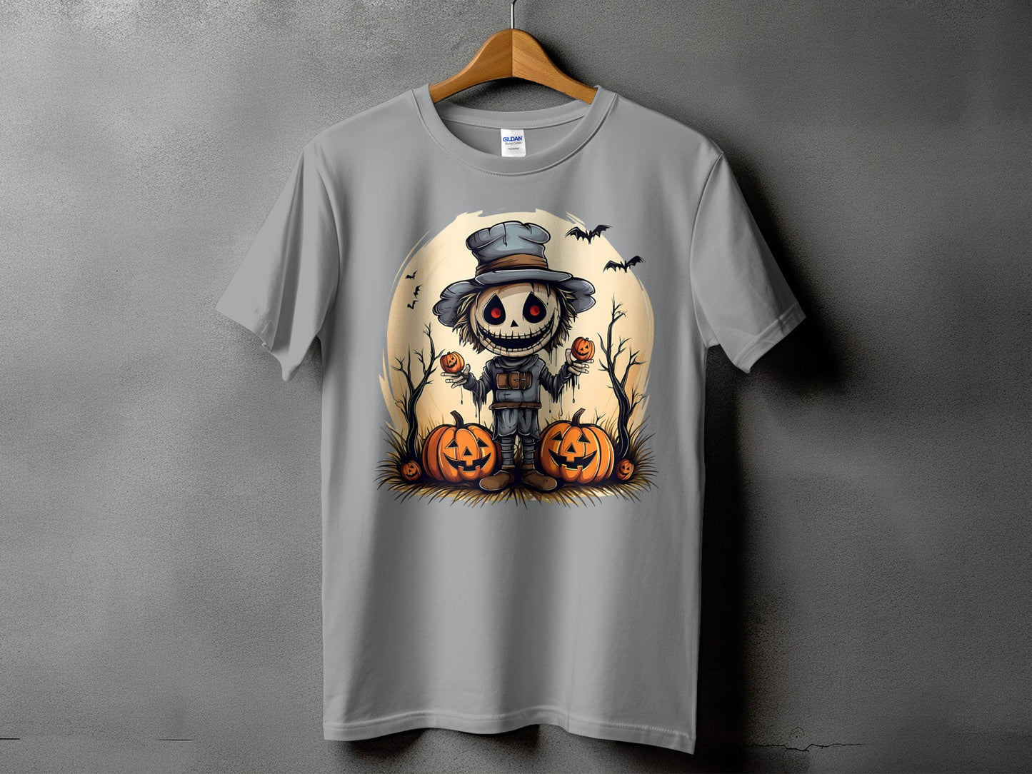 Scarecrow illustration with pumpkins and bats on a gray t-shirt.