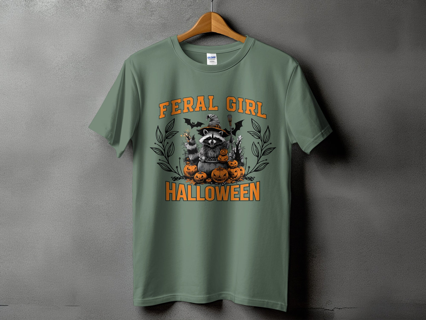 Green t-shirt with "FERAL GIRL HALLOWEEN" text and raccoon graphic.