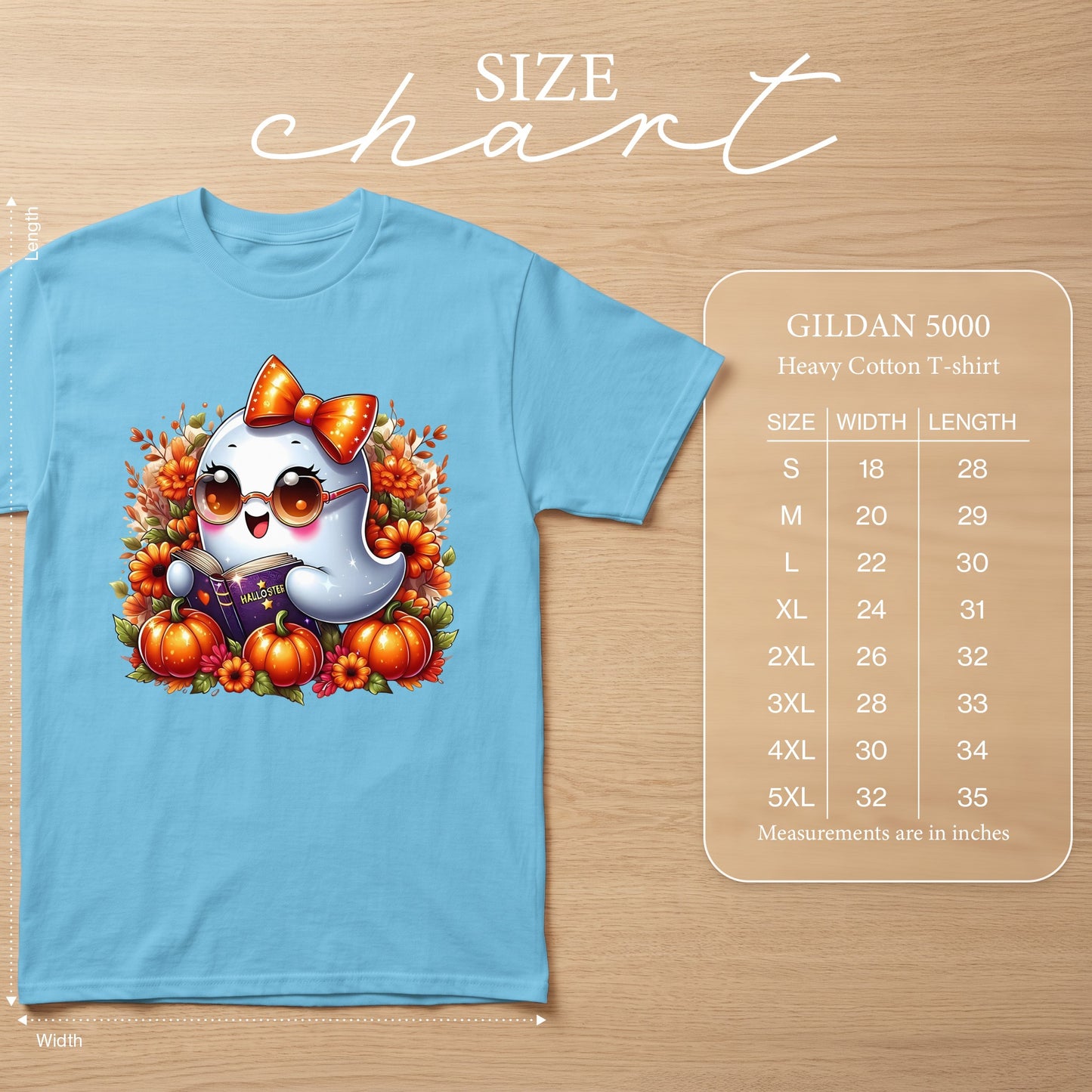Light blue t-shirt with cartoon ghost reading a book and Halloween decorations. Includes size chart.