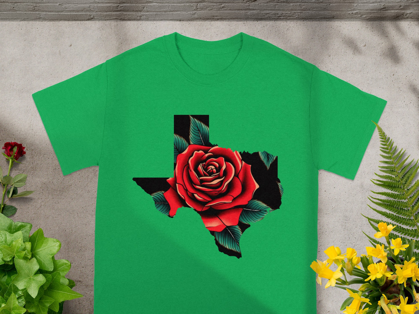 Green t-shirt with a Texas outline filled with a red rose and green leaves.