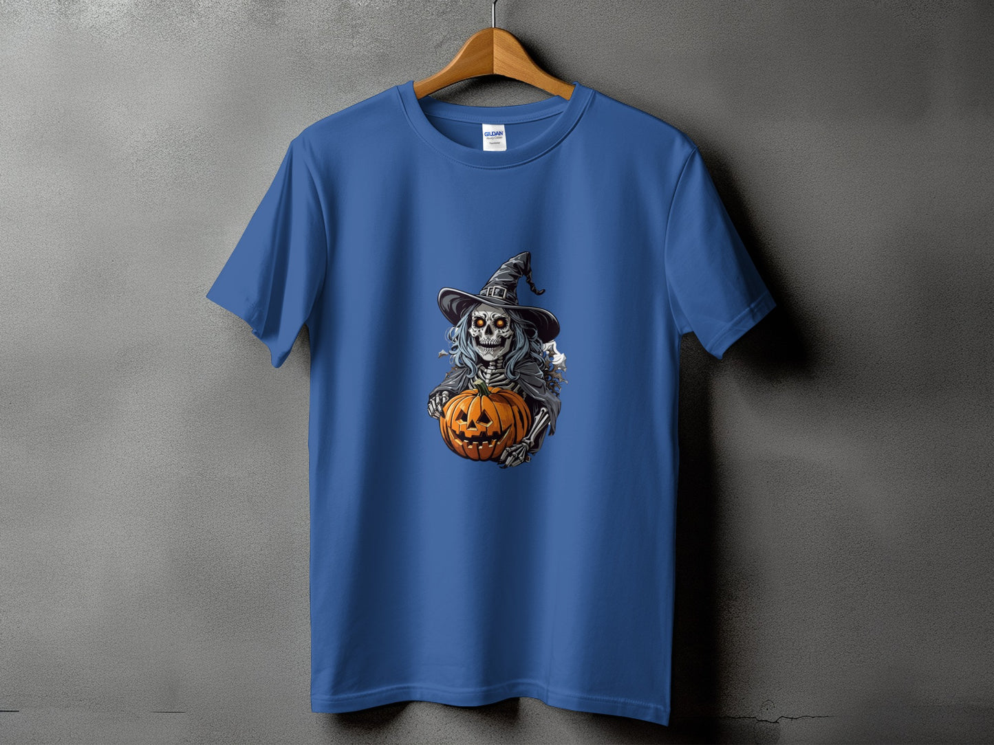 Blue t-shirt with a skeleton witch holding a pumpkin graphic.