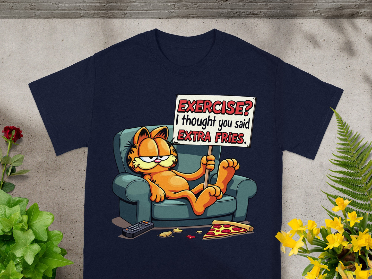 Garfield lounging on a couch holding a sign that says "Exercise? I thought you said extra fries."
