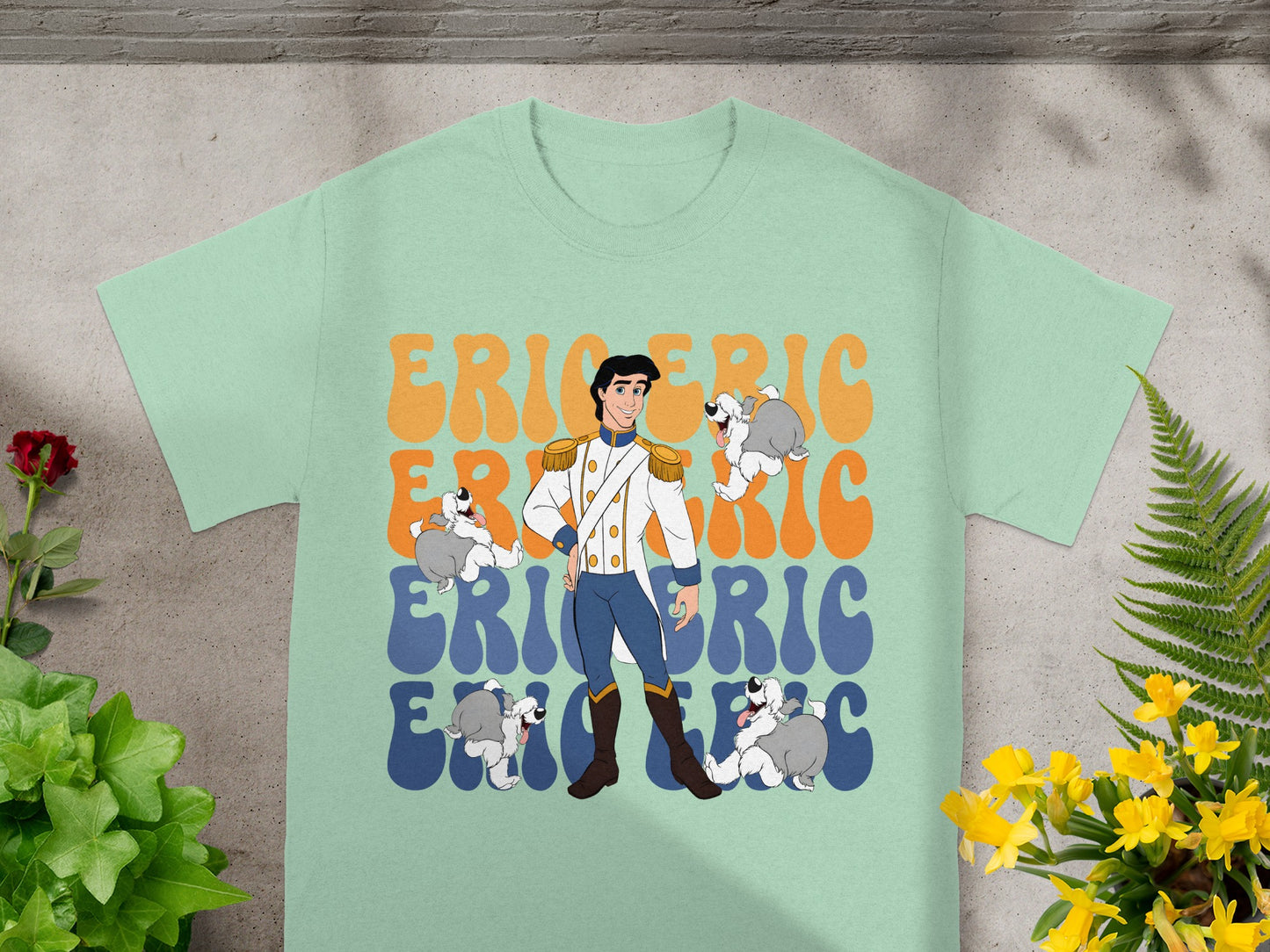 Prince Eric and his dogs graphic on a light mint green t-shirt.