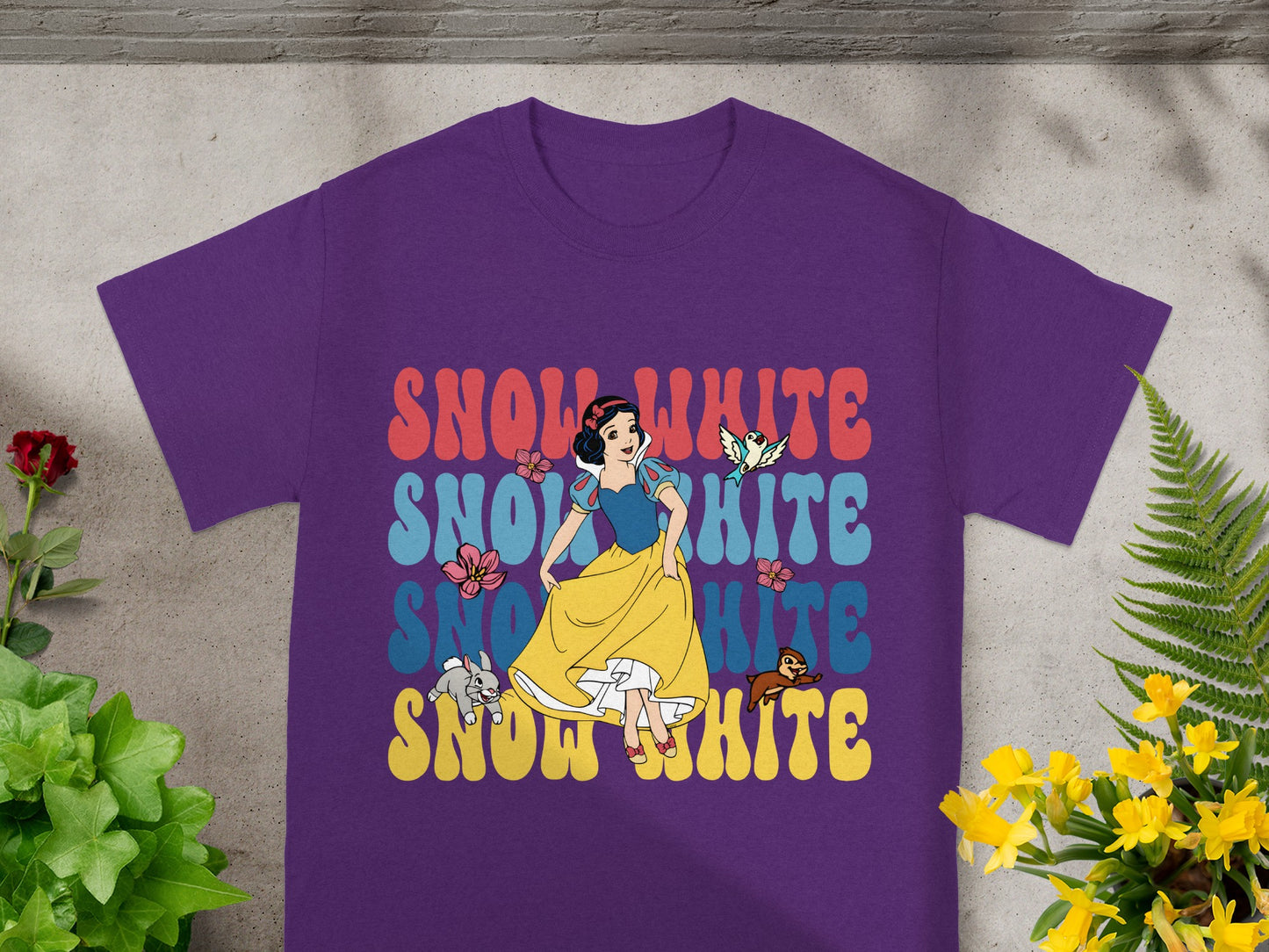 Purple t-shirt with retro "Snow White" text and illustration.