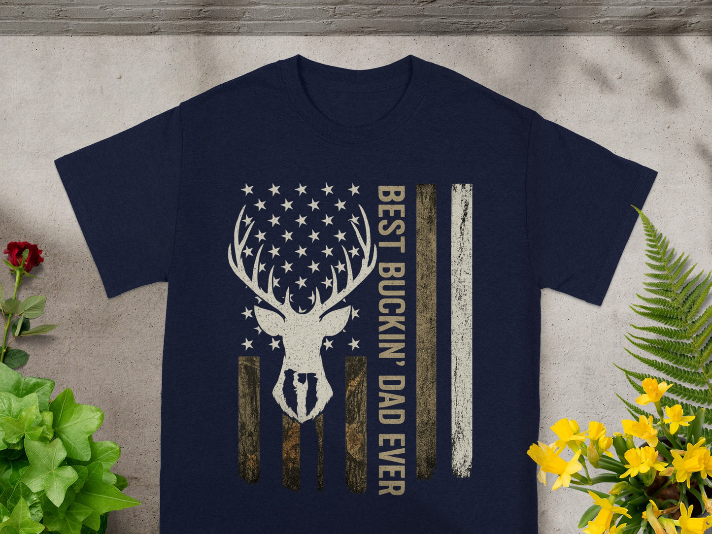 Navy t-shirt with distressed deer head flag and text "BEST BUCKIN' DAD EVER".
