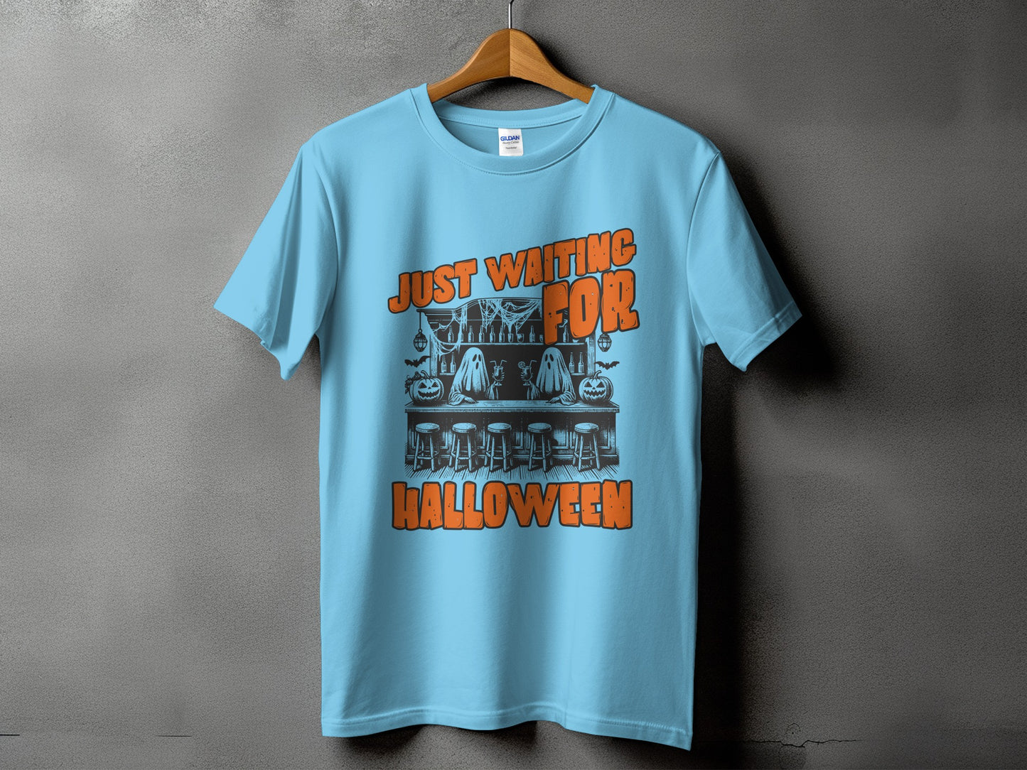 Light blue t-shirt with "Just Waiting for Halloween" graphic featuring ghosts and pumpkins.