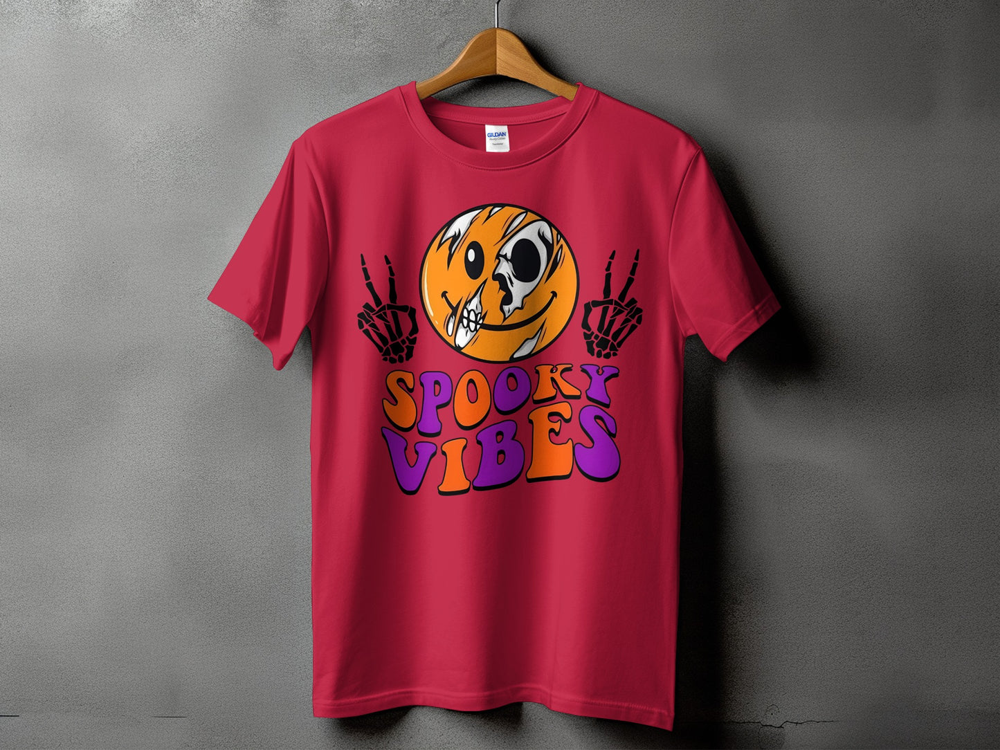 Red t-shirt with spooky vibes graphic, featuring a skull-faced smiley and skeleton hands.
