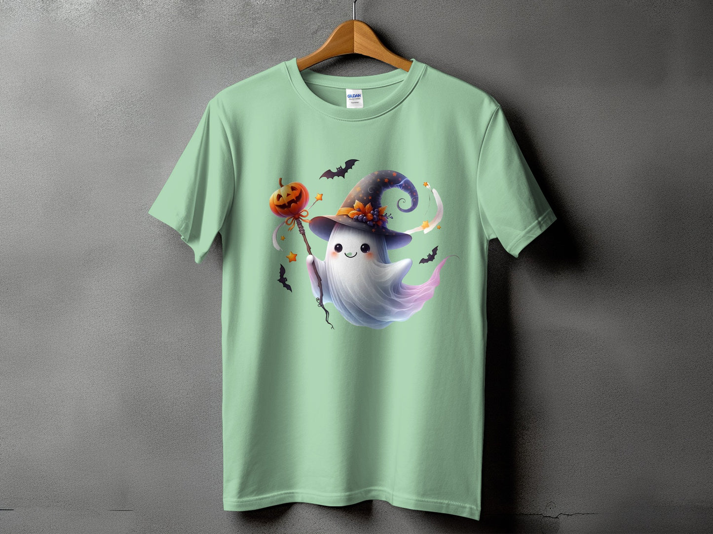 Mint t-shirt with a cute ghost wearing a witch hat and holding a pumpkin lollipop.