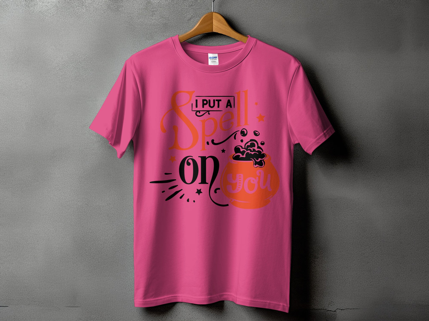 Pink t-shirt with graphic text "I PUT A Spell on YOU" and a cauldron.