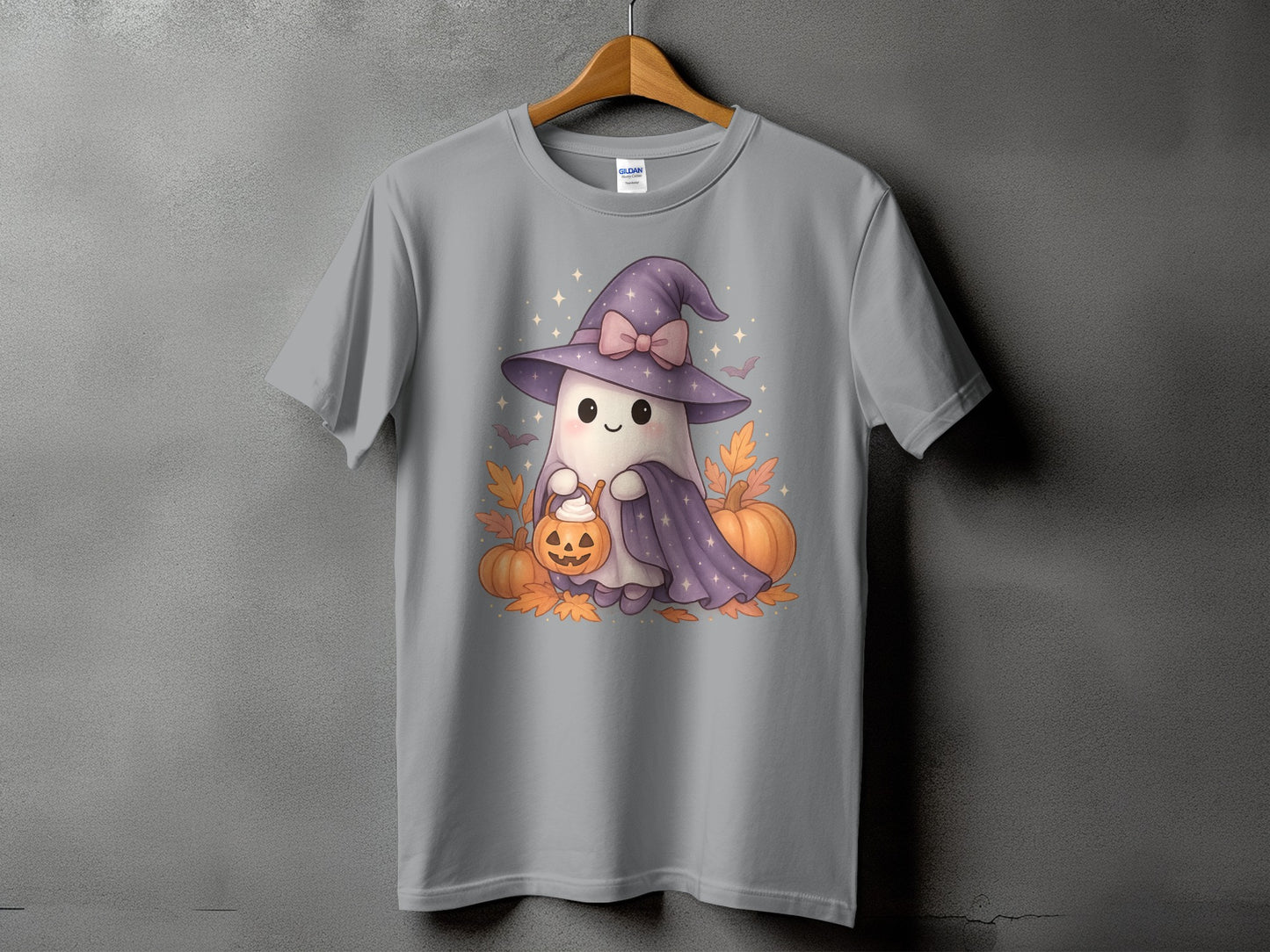 Gray t-shirt with a cute ghost in a witch hat holding a jack-o'-lantern bucket.