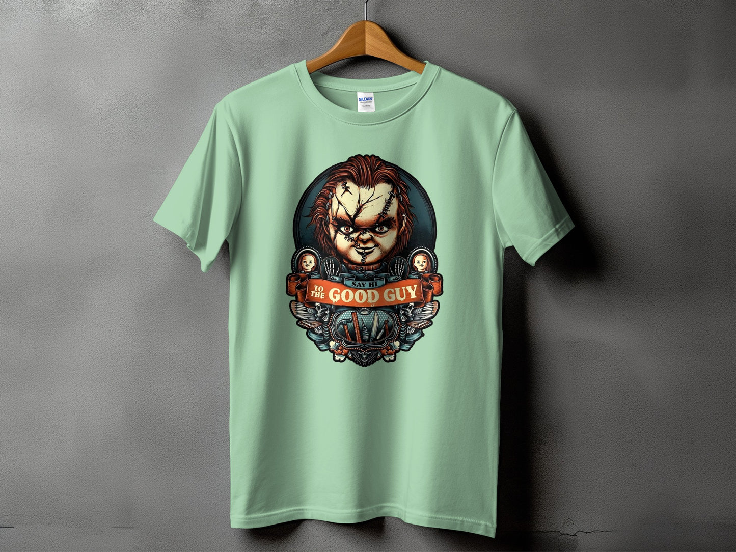 Light green t-shirt with Chucky graphic reading "Say Hi To The Good Guy."