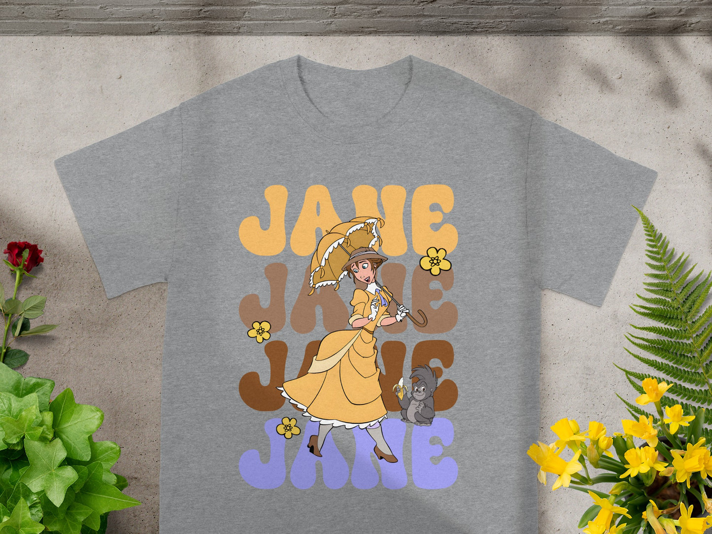Grey t-shirt with "JANE JANE JANE" text and illustration of a woman with umbrella.