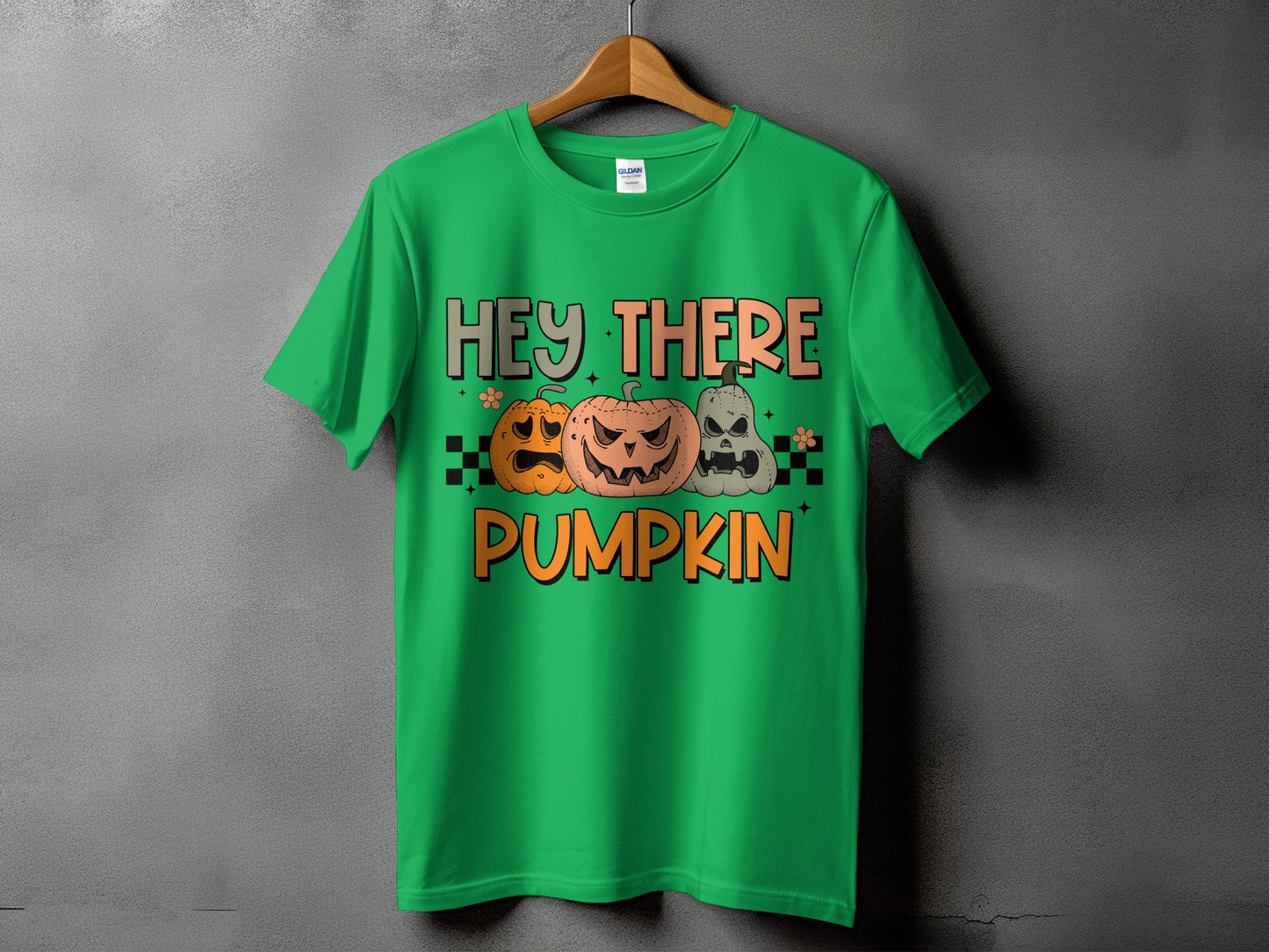 Green t-shirt with "Hey There Pumpkin" and three carved pumpkins.