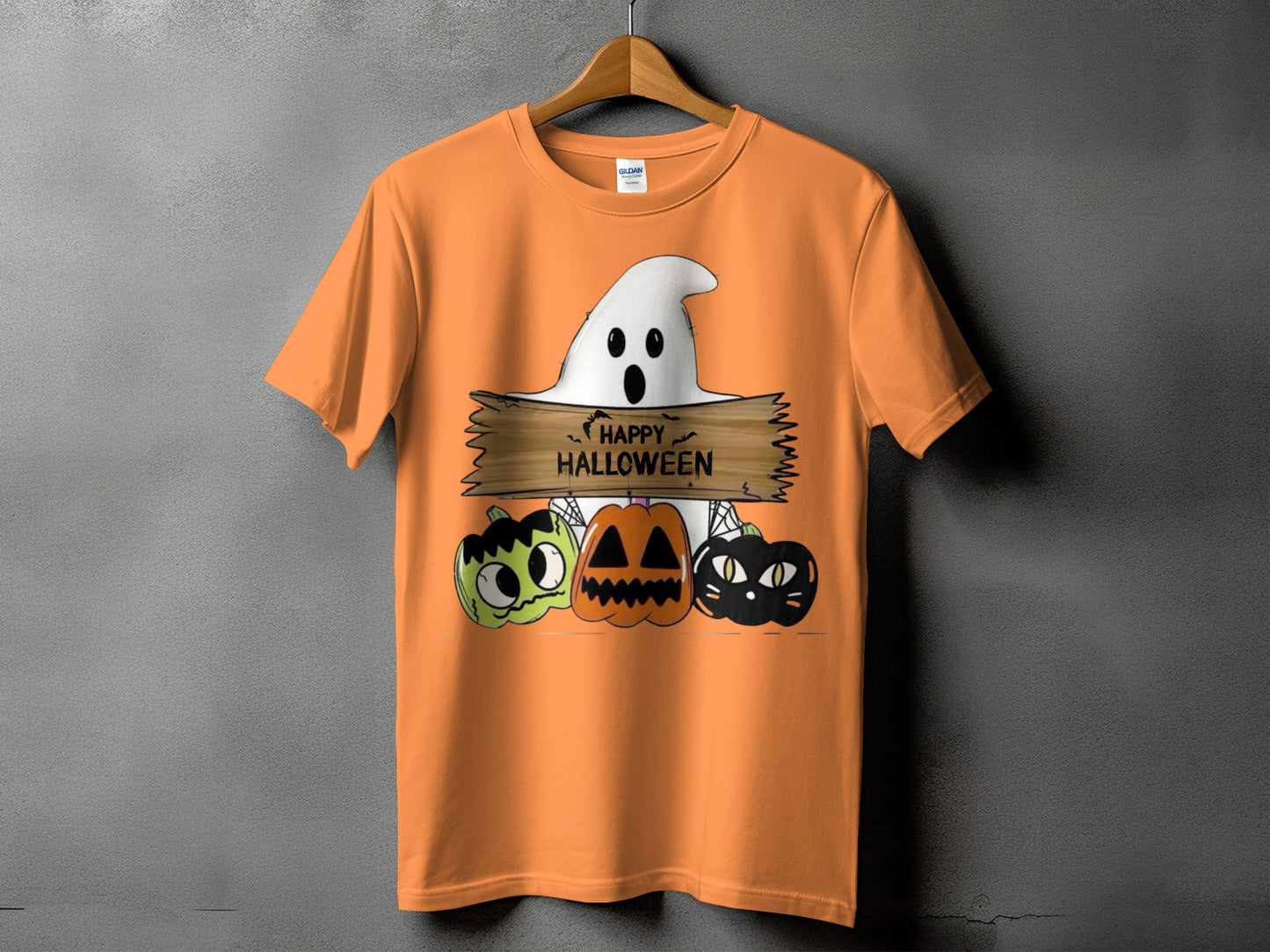 Orange t-shirt with a Halloween design featuring a ghost, pumpkins, and a black cat.