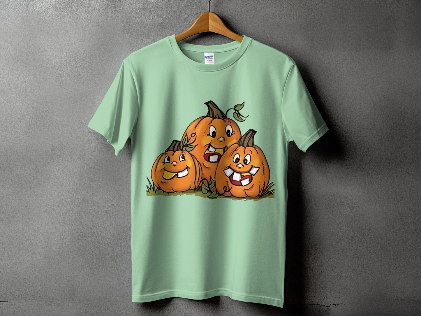 T-shirt with a graphic of three smiling cartoon pumpkins with buck teeth.