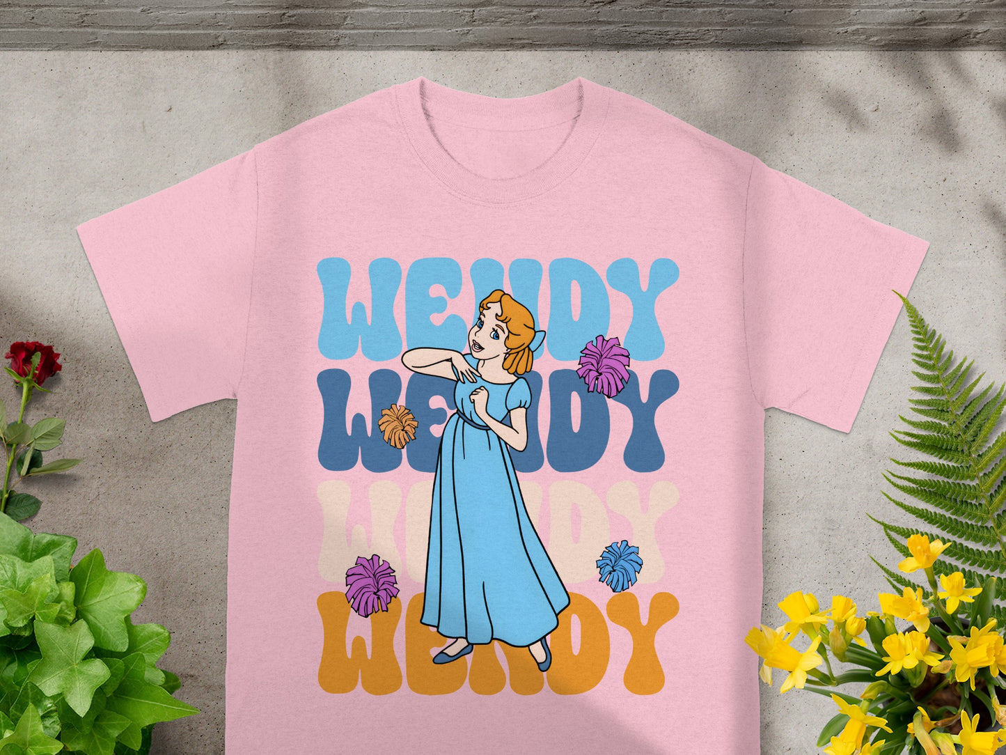 Pink t-shirt with "Wendy" in wavy blue and yellow lettering.