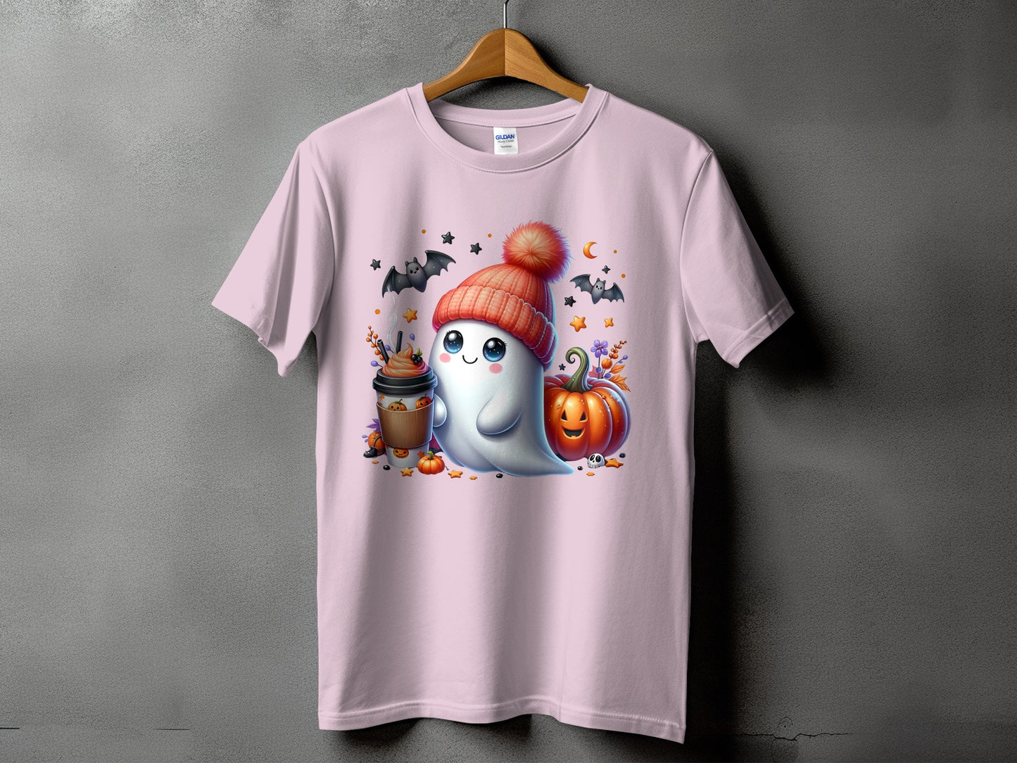 Pink t-shirt with a cute ghost in a beanie, pumpkin, and coffee for Halloween.