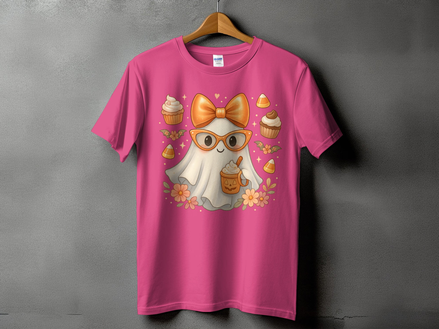 Pink t-shirt with a Halloween ghost graphic holding a pumpkin spice latte.