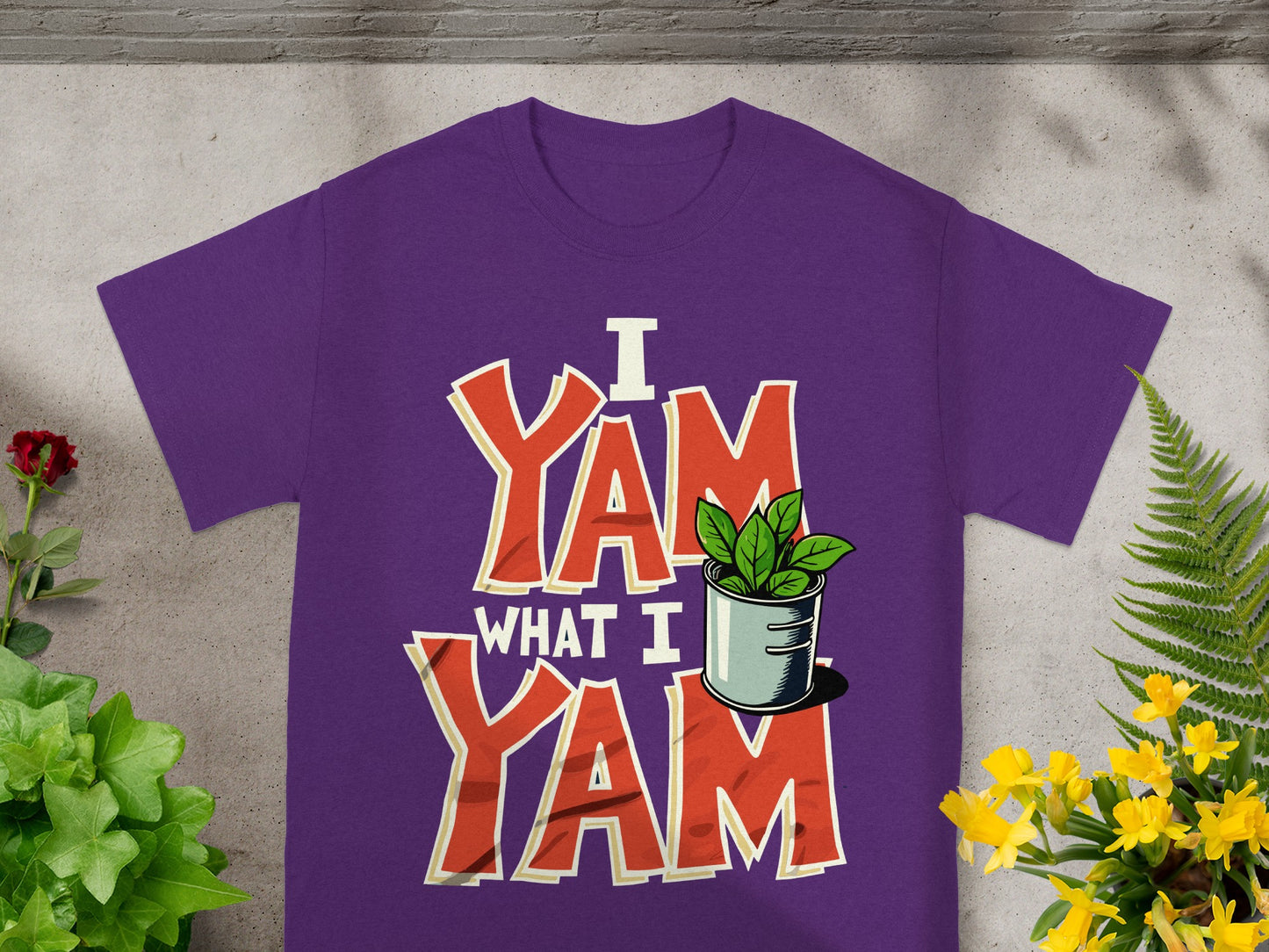 Purple t-shirt with "I Yam What I Yam" text and a potted plant.