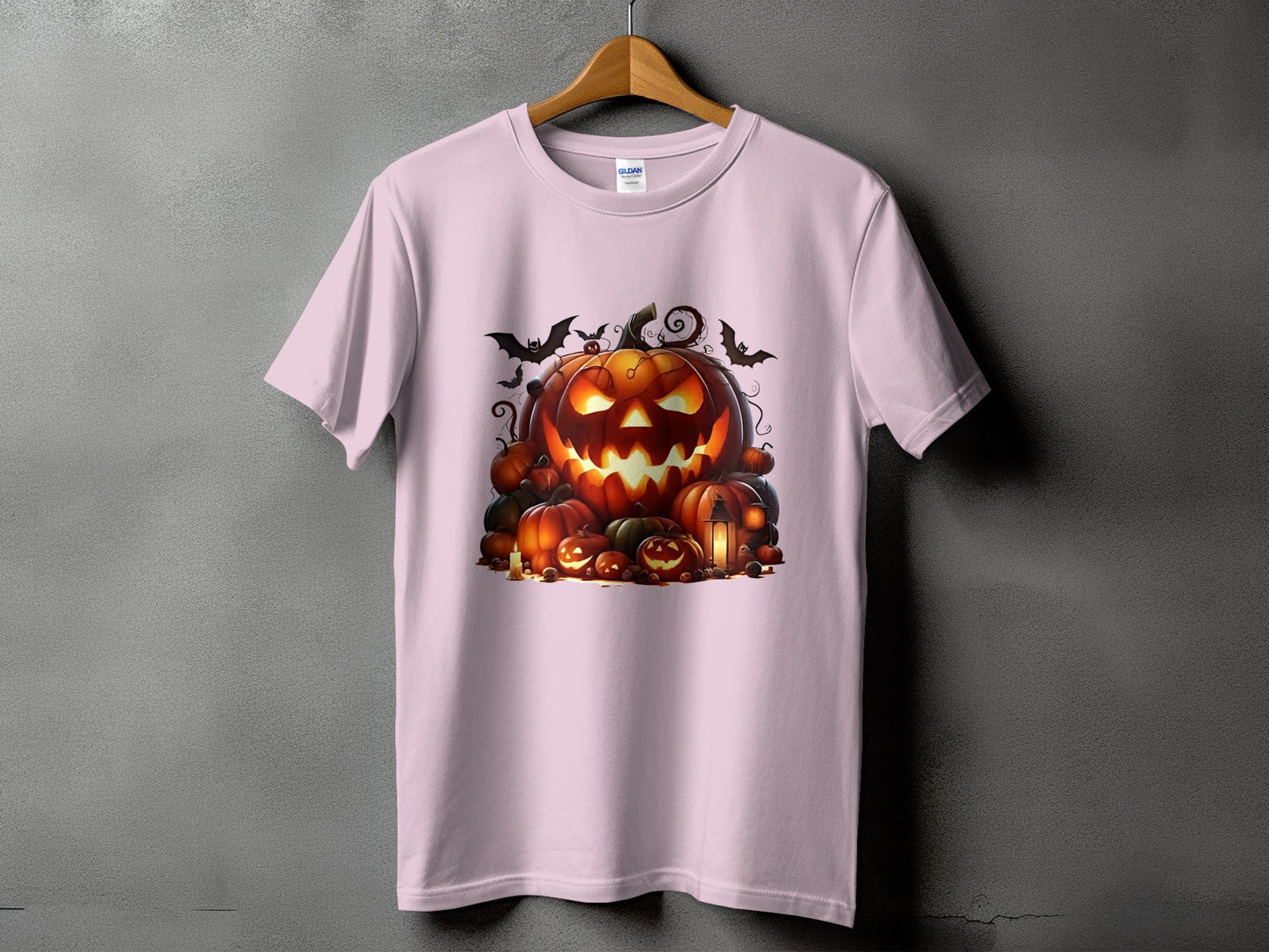 Light pink t-shirt with a Halloween jack-o'-lantern and pumpkin graphic.