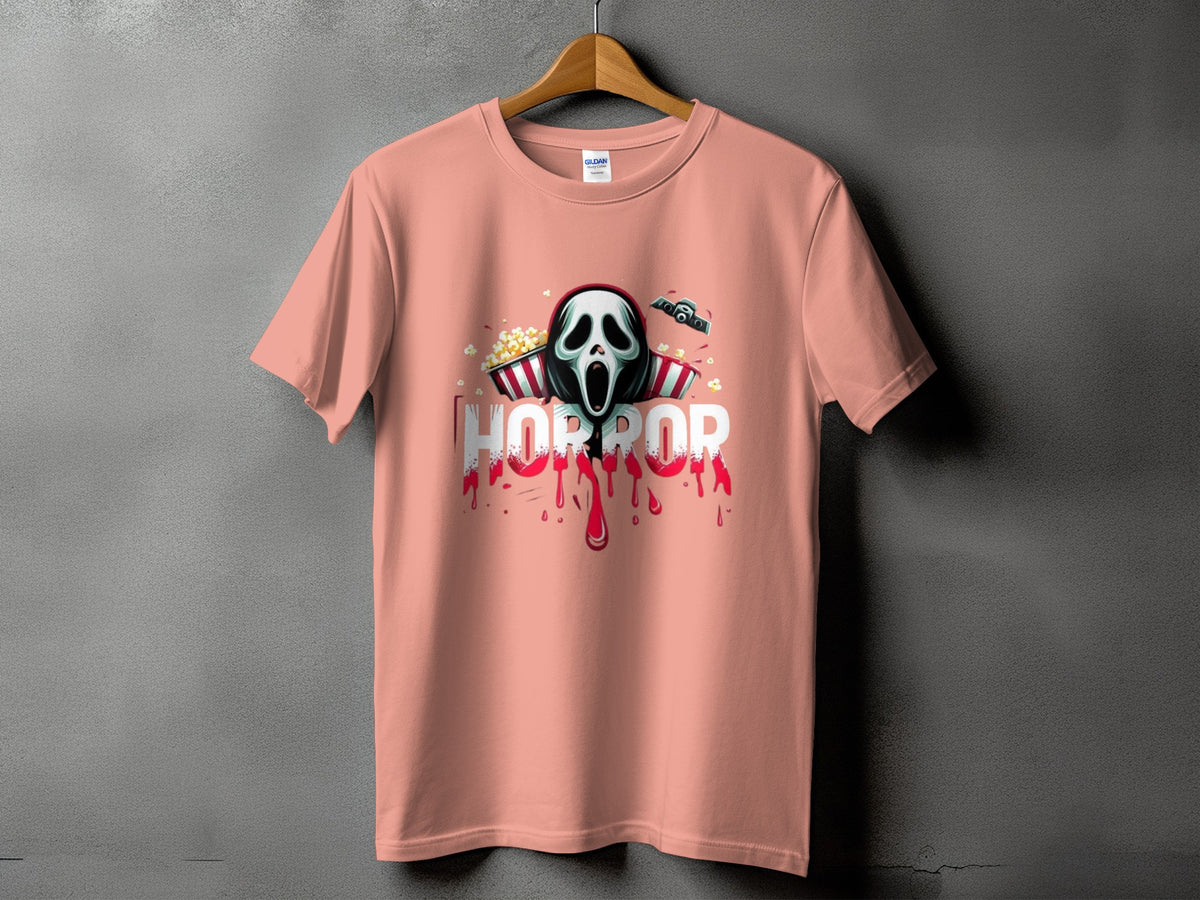 Peach t-shirt with a horror mask, popcorn, and dripping blood graphic.
