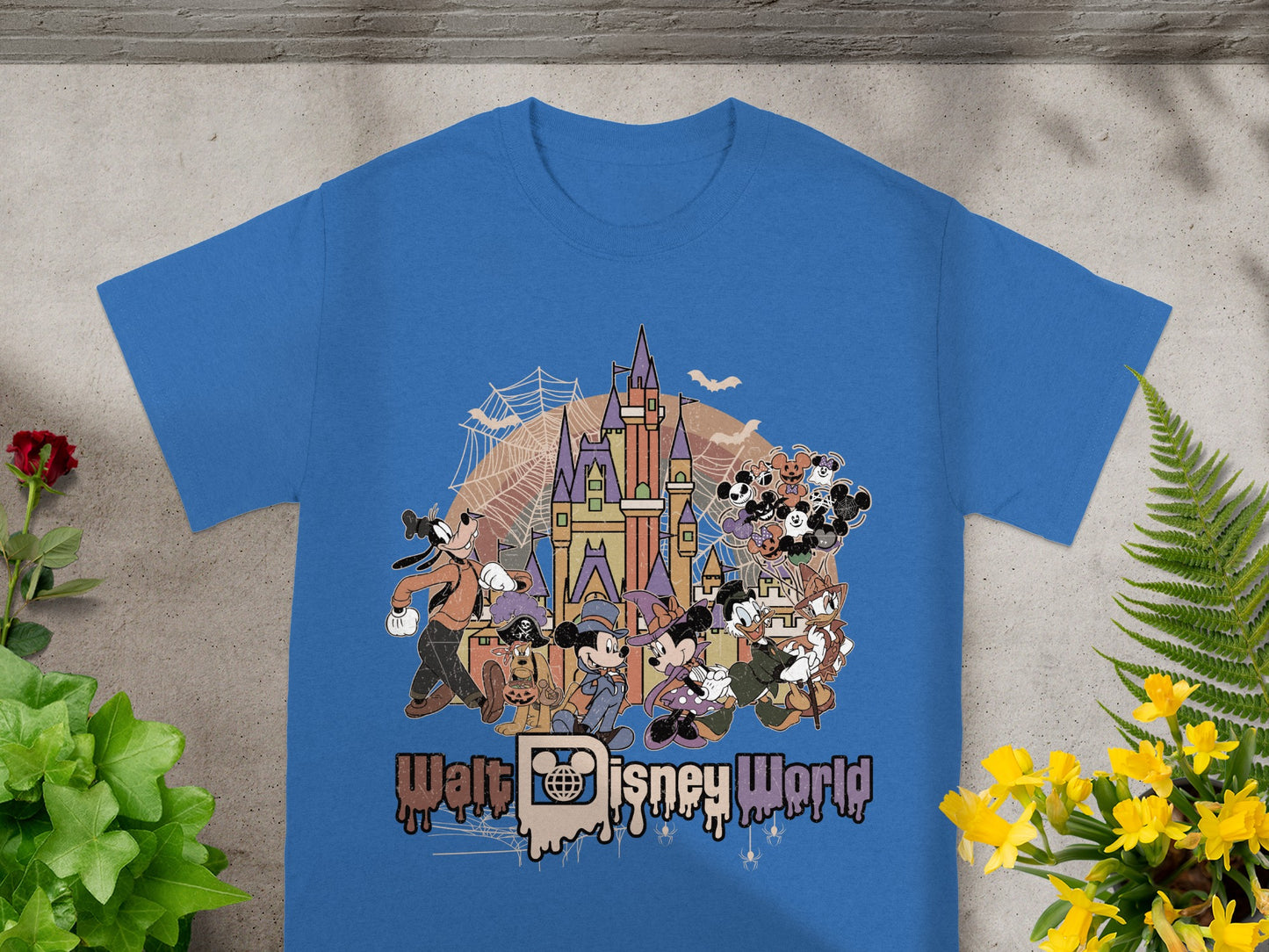 Walt Disney World castle with characters and Halloween theme on blue t-shirt.
