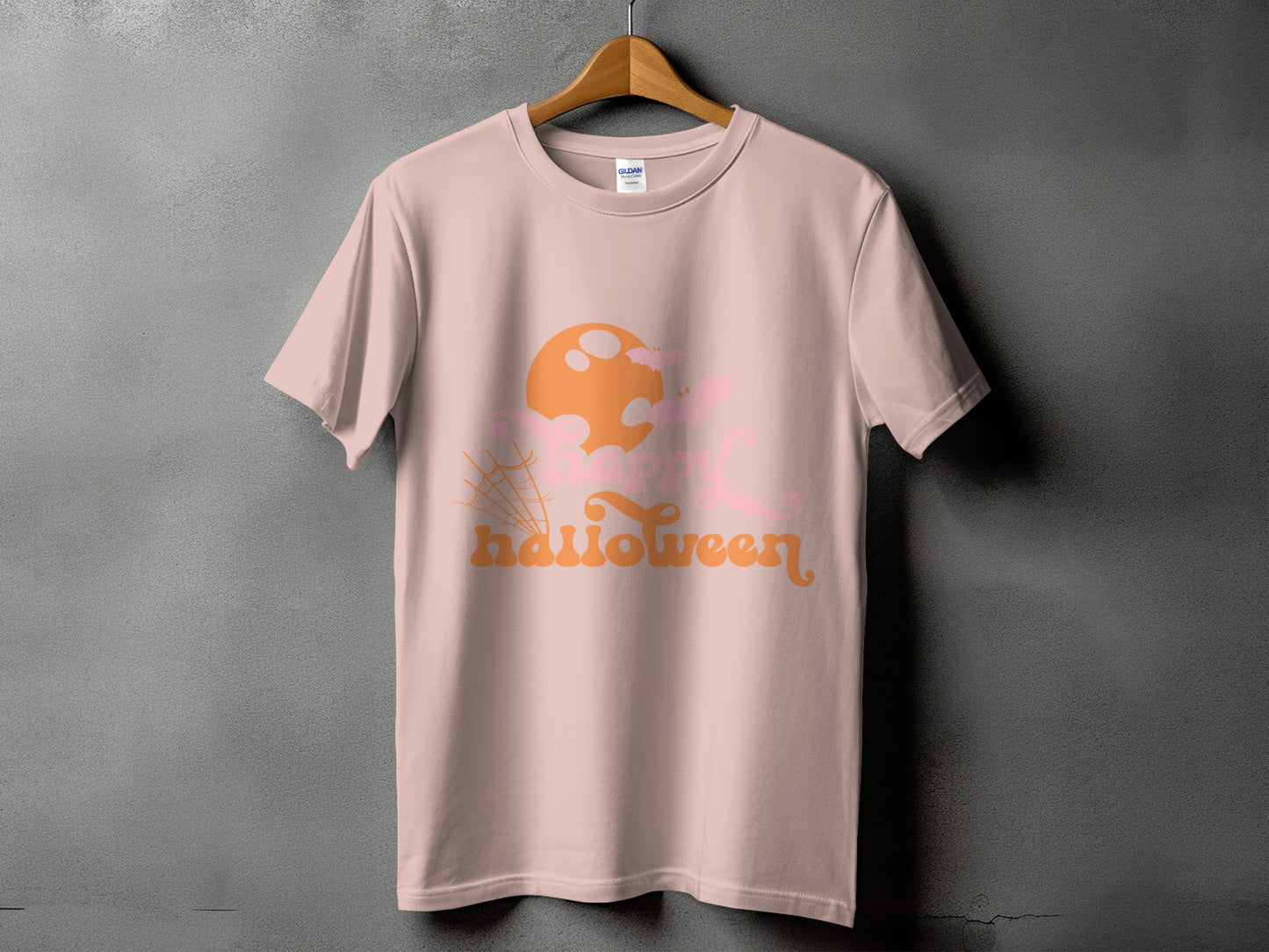 Pink t-shirt with orange and pink Halloween graphic and text.