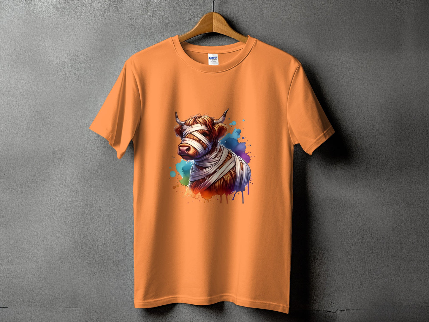 Orange t-shirt with a Highland cow graphic bandaged like a mummy.