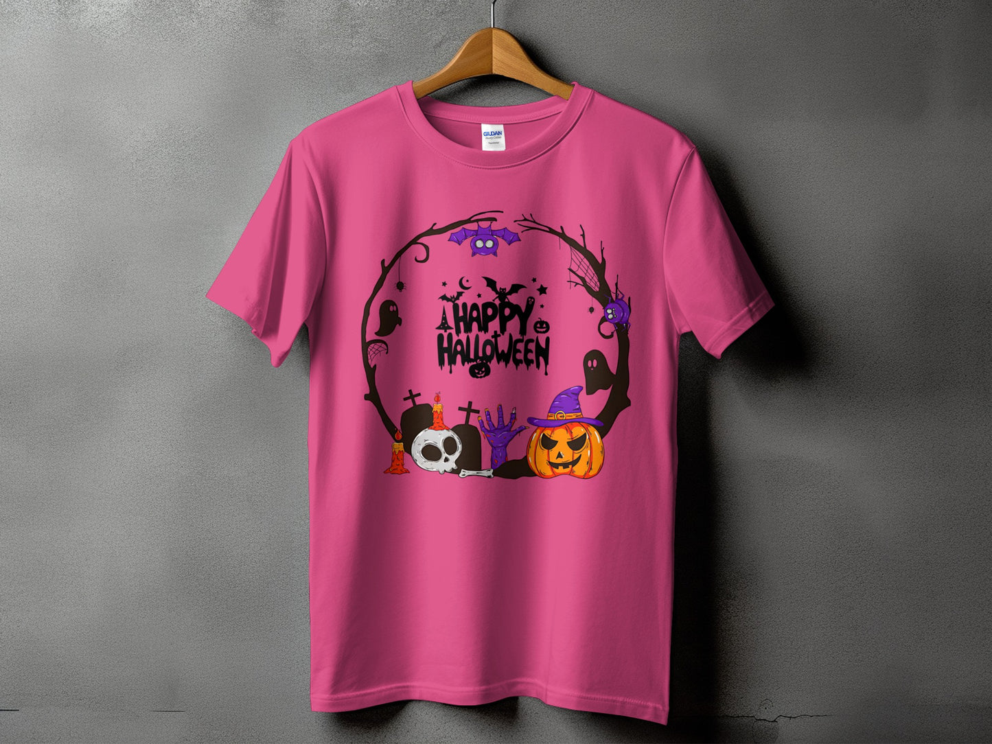 Pink t-shirt with a round Halloween graphic featuring a pumpkin, skull, and text.
