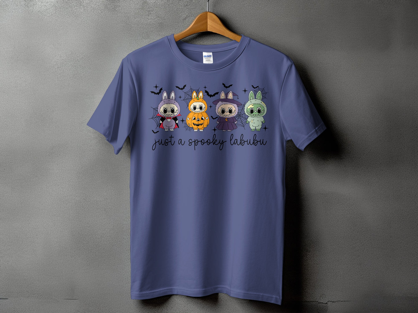 Purple t-shirt with four Halloween-themed Labubu characters and text "just a spooky labubu".