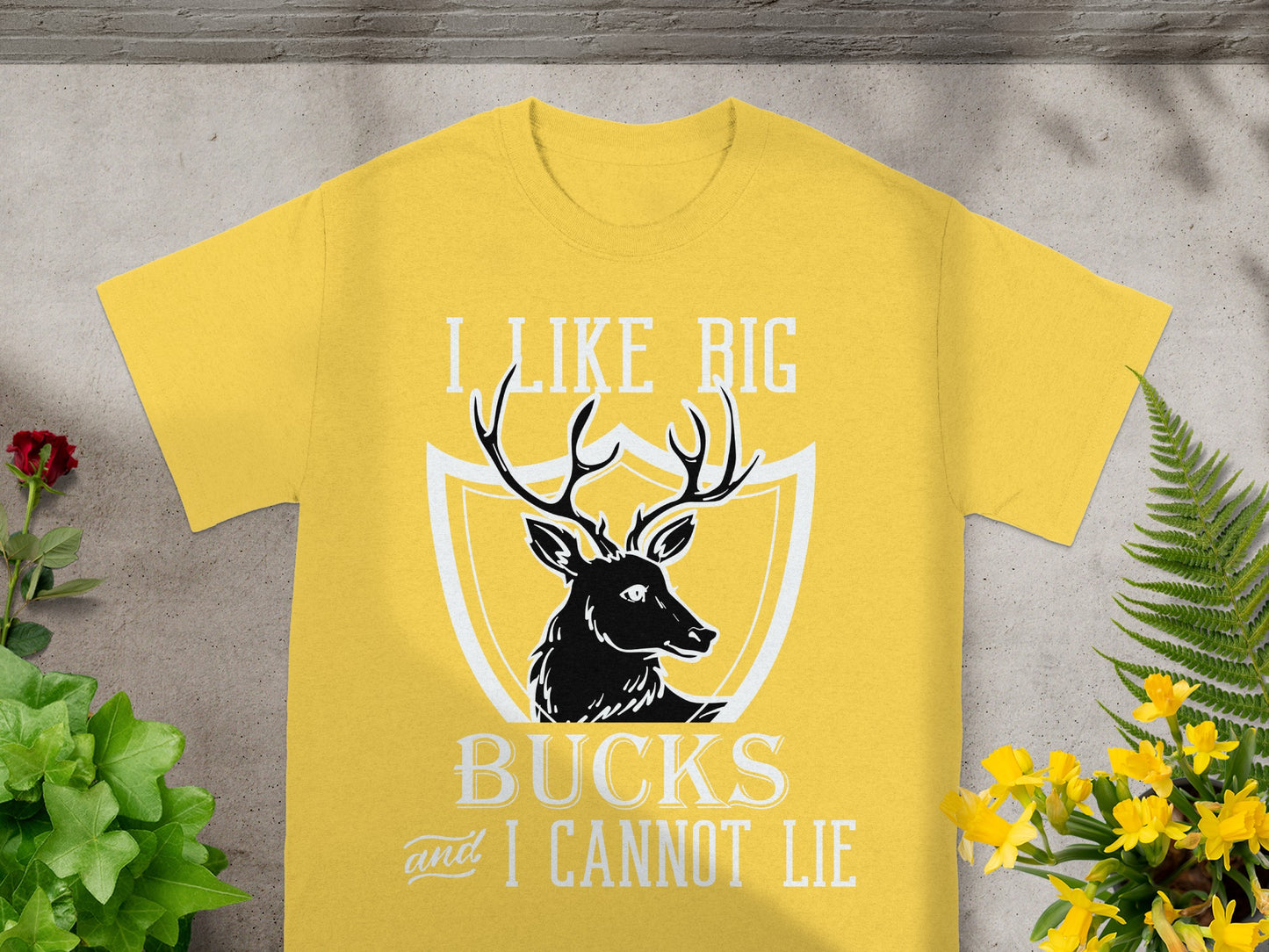 Yellow t-shirt with deer silhouette and text "I LIKE BIG BUCKS and I CANNOT LIE".