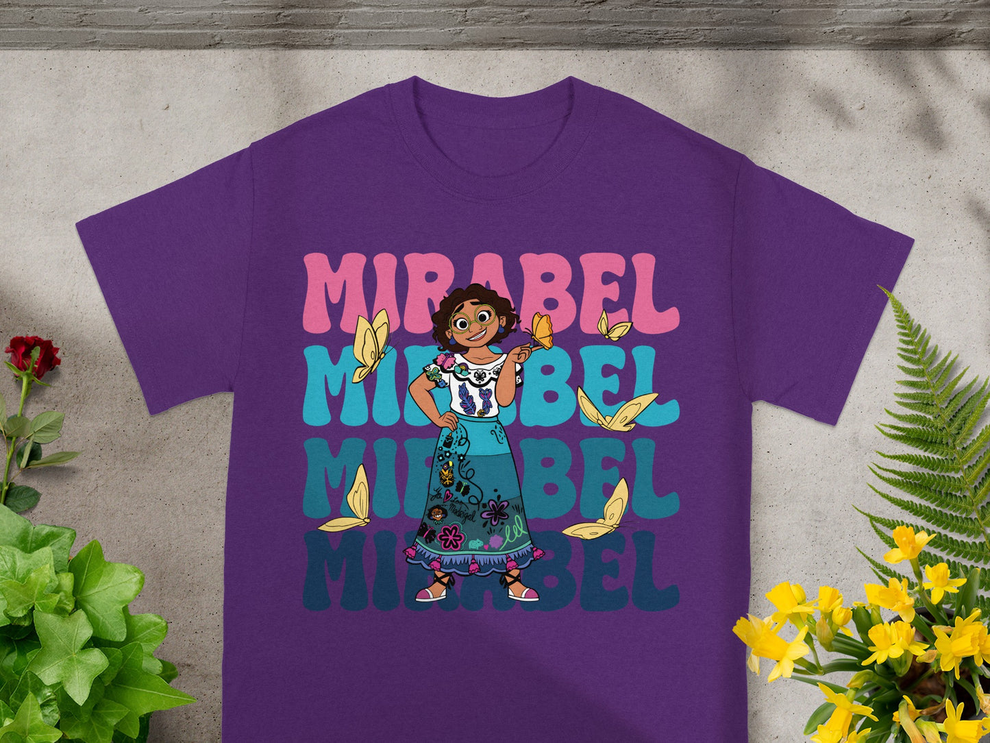 Purple t-shirt with Mirabel Madrigal and colorful text "MIRABEL".