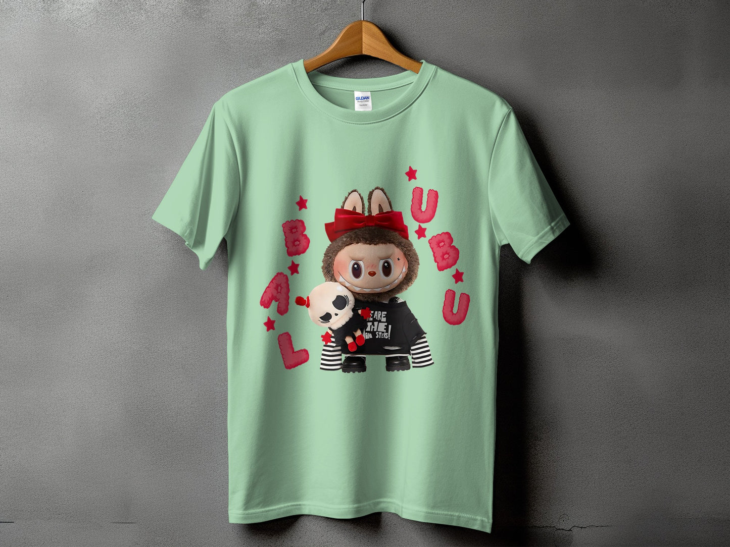 Light green t-shirt with a cartoon character holding a skull plushie.