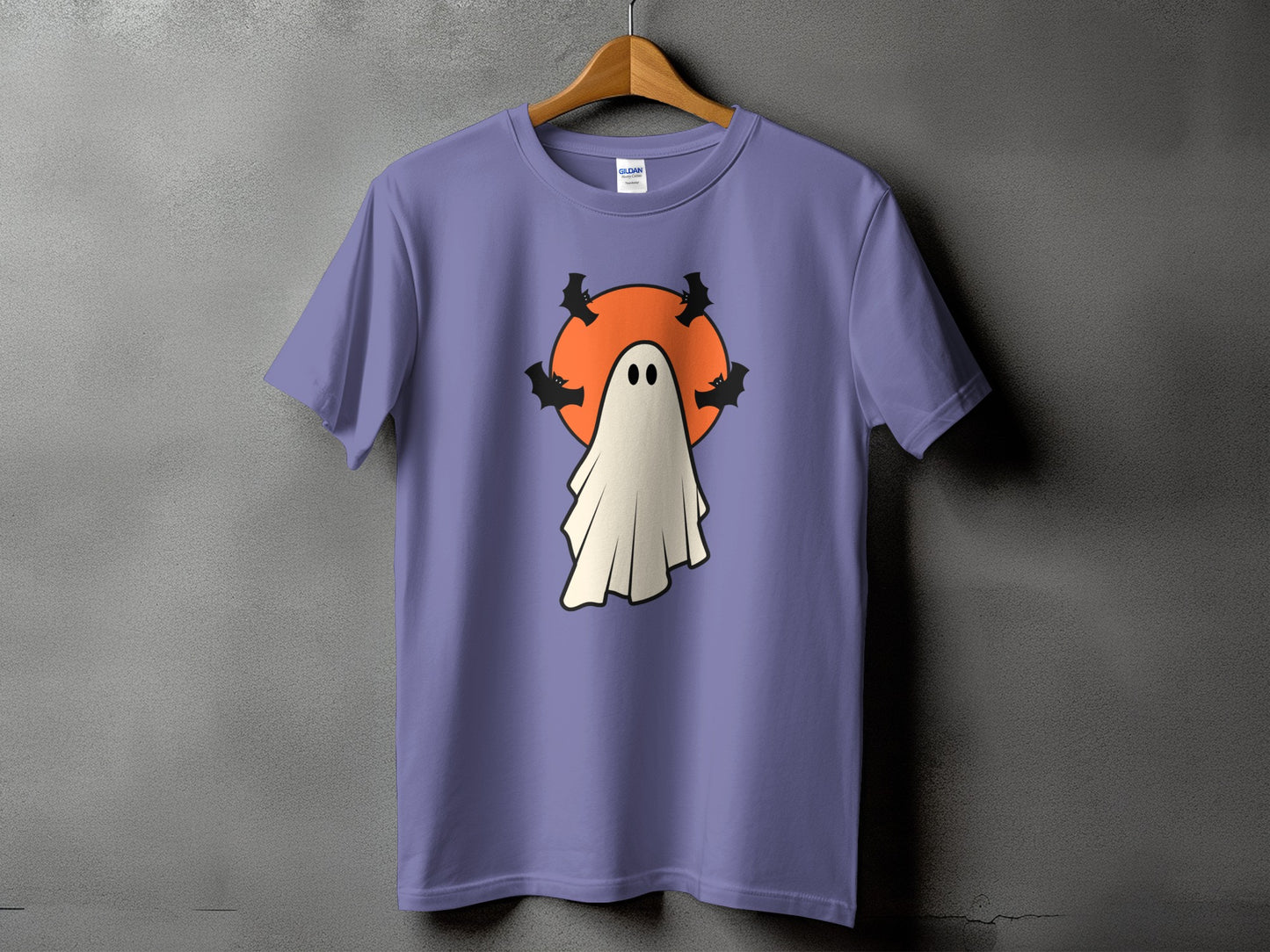 Purple t-shirt with a cartoon ghost and bats on an orange circle.