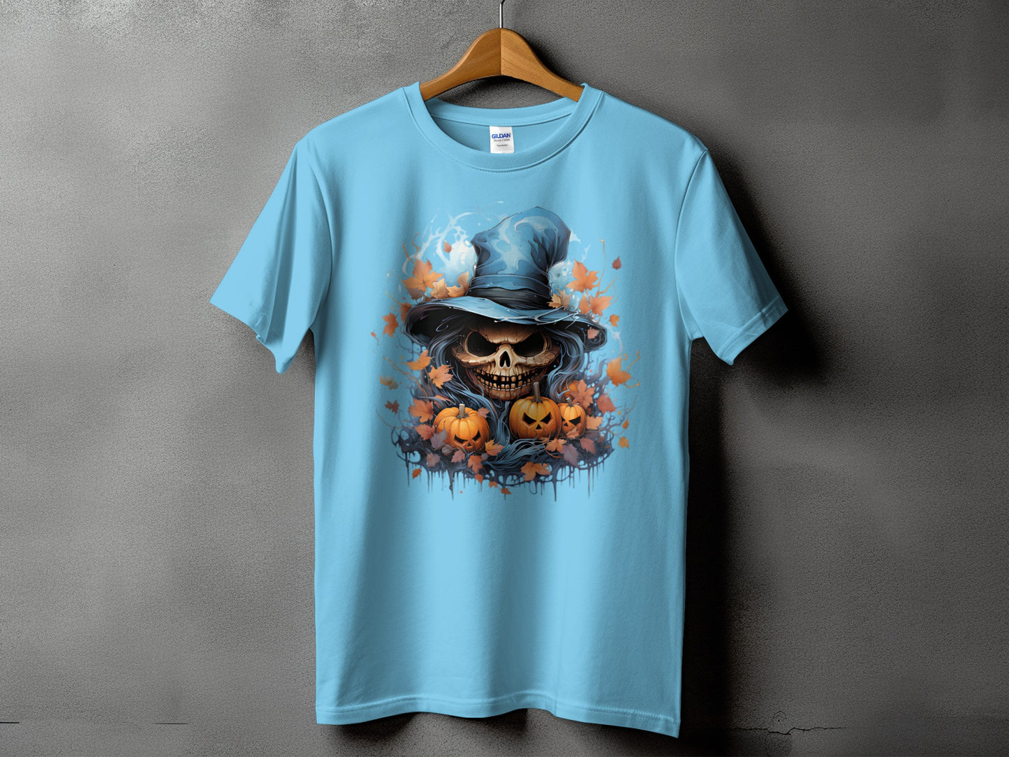 Light blue t-shirt with a skull, pumpkins, and witch hat Halloween graphic.