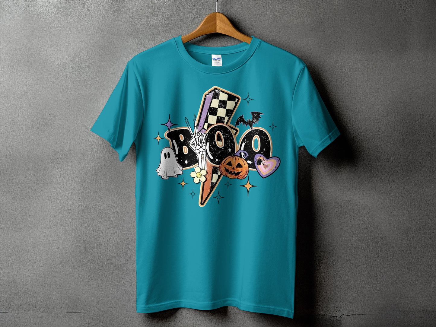 Turquoise t-shirt with "Boo" graphic featuring skeleton hand, ghost, pumpkin, and bats.