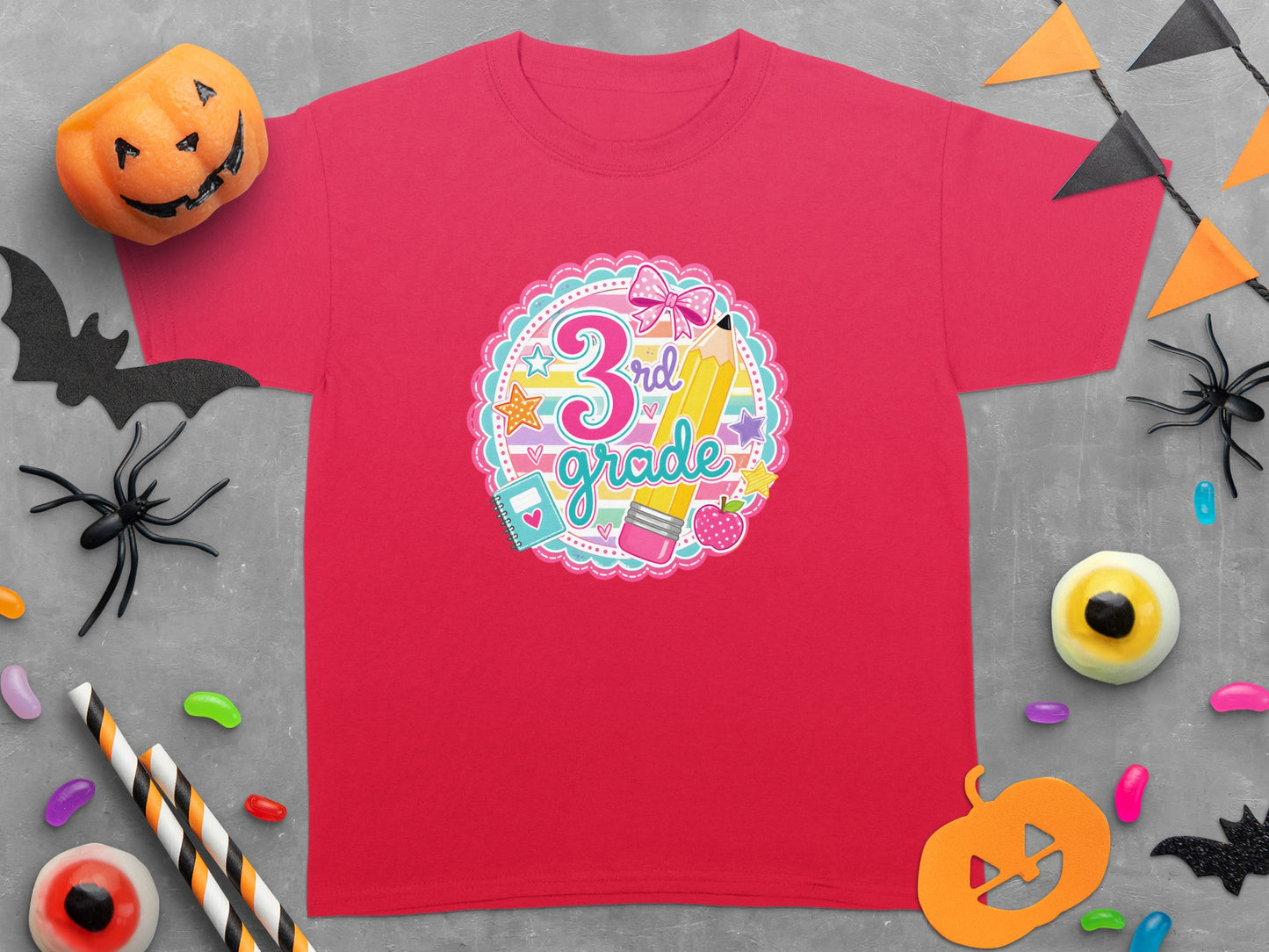 Ringer tee with "3rd grade" graphic, featuring a pencil, bow, and school supplies.