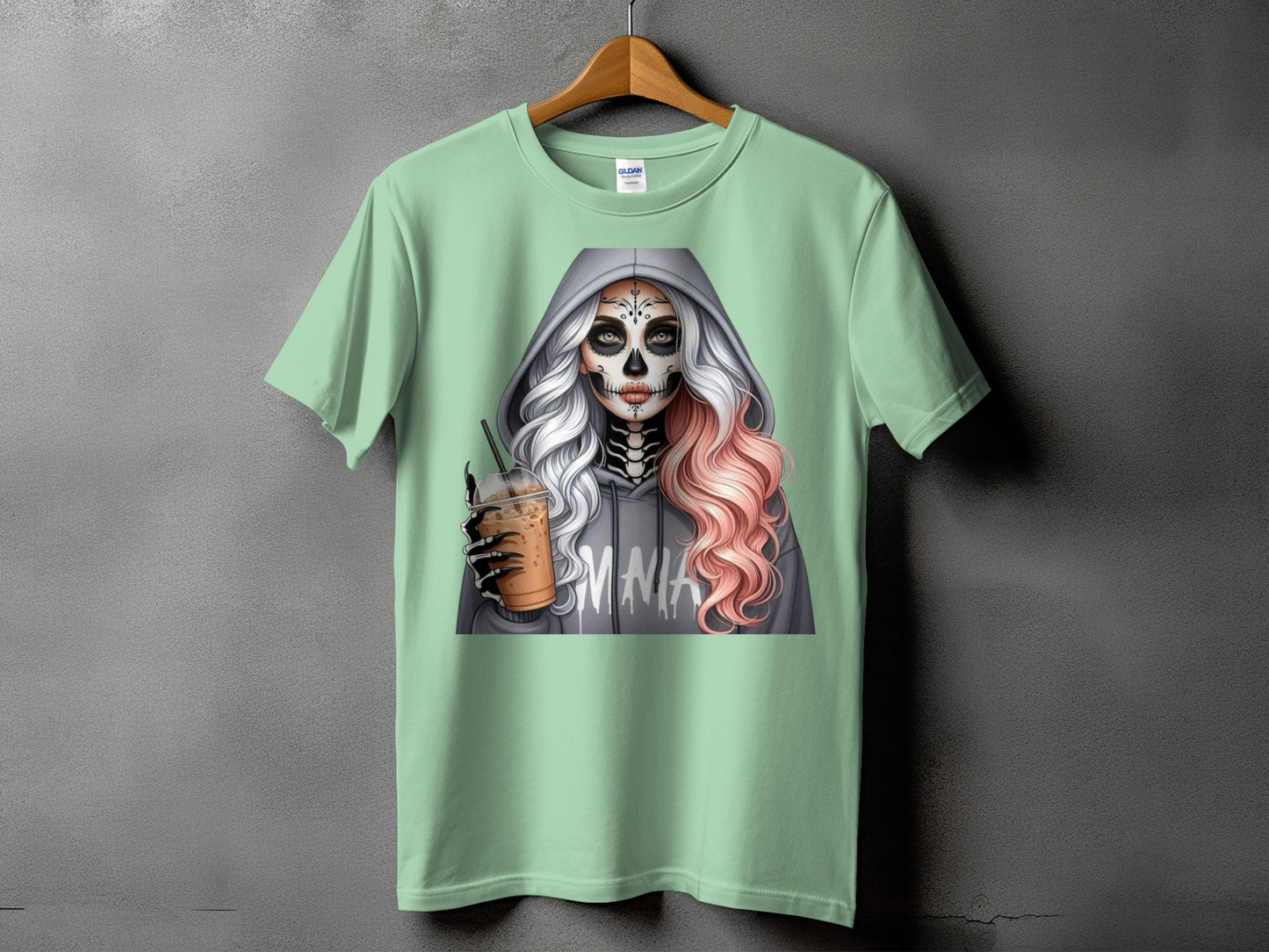 Mint t-shirt with graphic of skeleton woman holding iced coffee, "MMA" text.