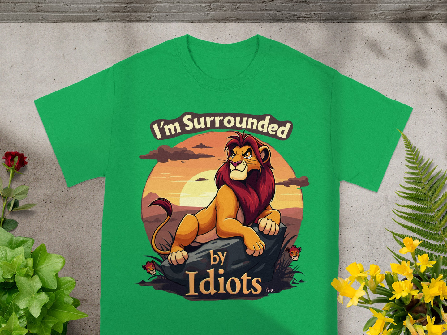 Green t-shirt with a lion illustration and the text "I'm Surrounded by Idiots."