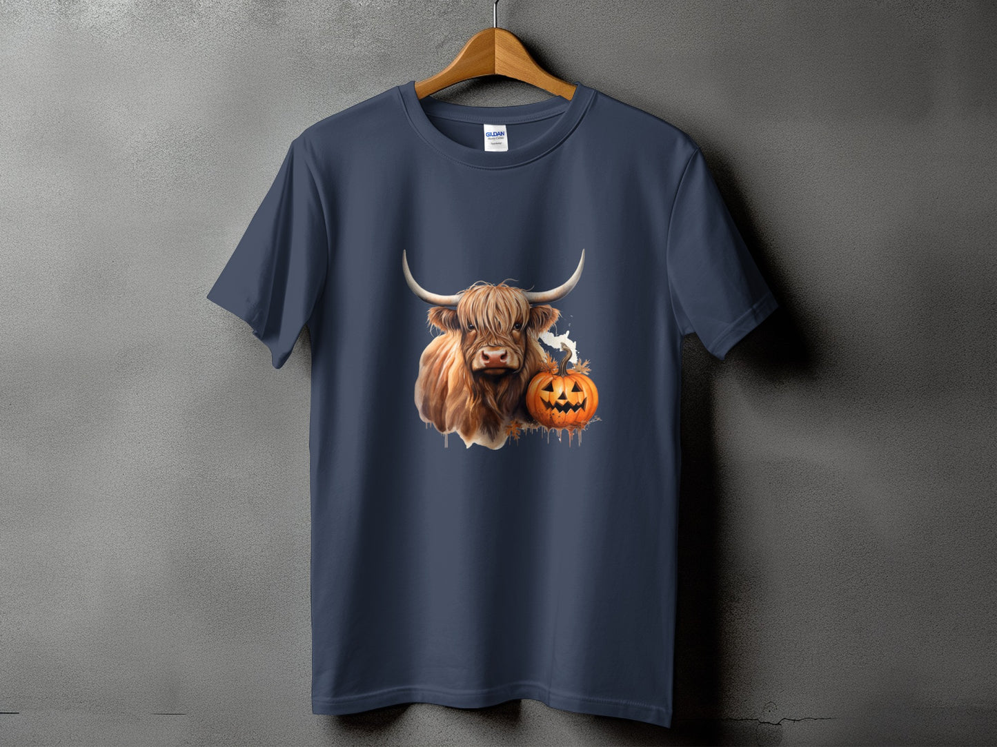 Dark blue t-shirt with a Highland cow, ghost, and jack-o'-lantern Halloween graphic.