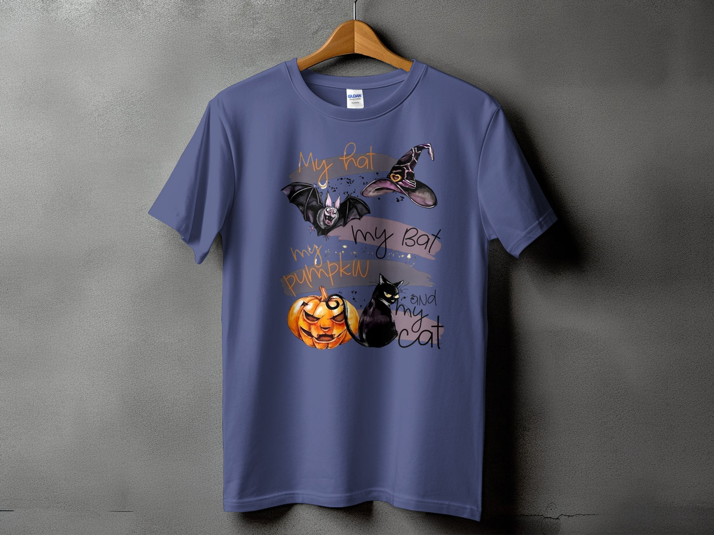 Purple t-shirt with Halloween graphic: witch hat, bat, pumpkin, and cat.