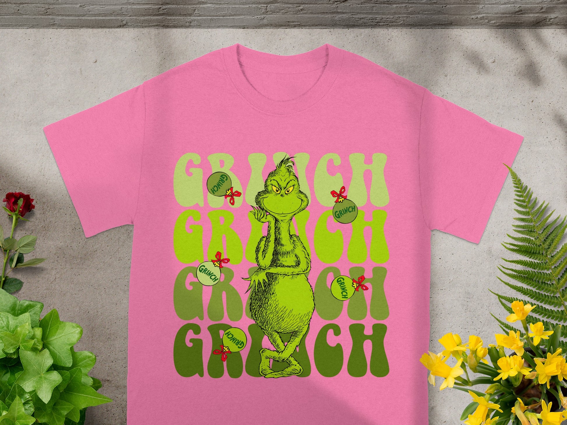 Pink t-shirt with Grinch graphic and text "Grinch".
