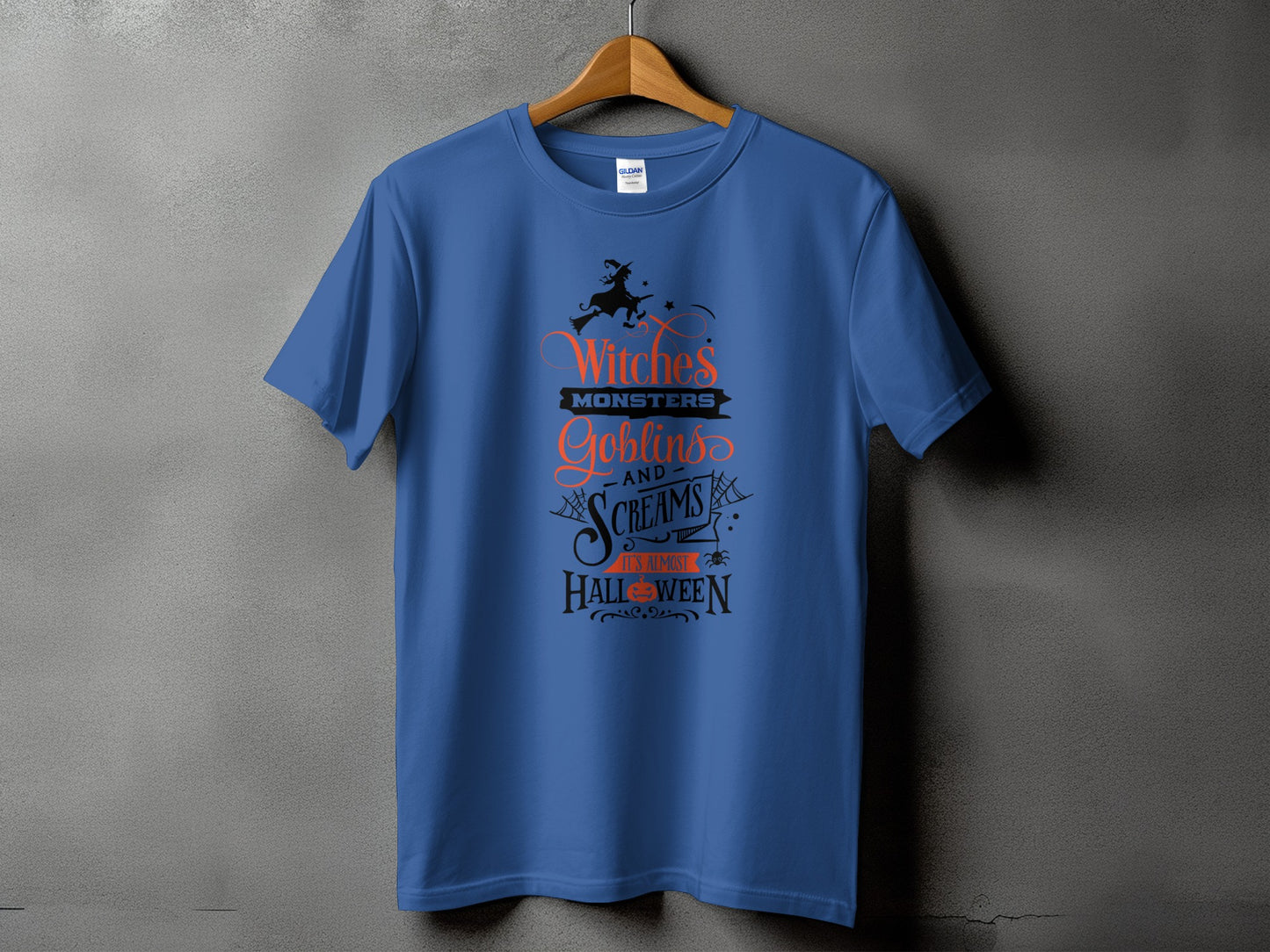 Blue t-shirt with "Witches, Monsters, Goblins, and Screams, It's Almost Halloween" text.
