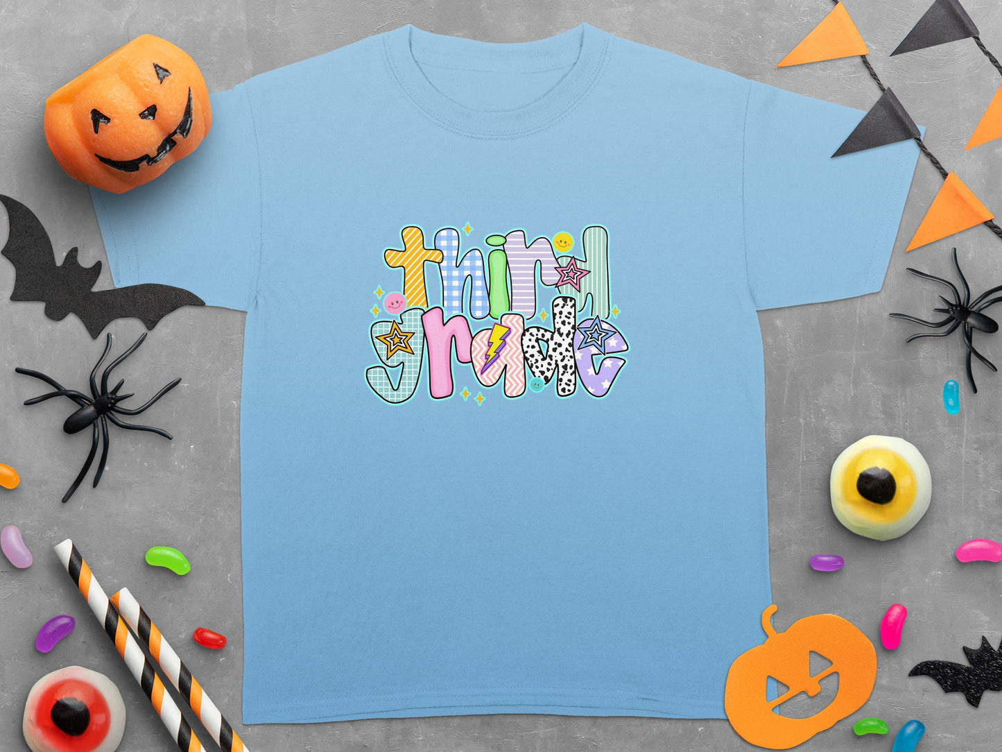 Light blue t-shirt with "Third Grade" text in colorful, patterned lettering