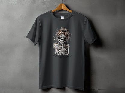 Dark grey t-shirt with skeleton holding coffee, text "MAMA NEEDS COFFEE".