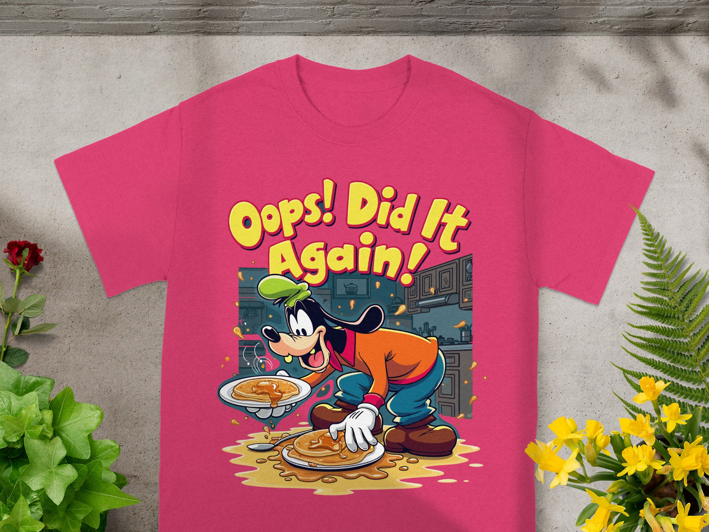 Pink t-shirt with cartoon Goofy spilling pancakes and text "Oops! Did It Again!".
