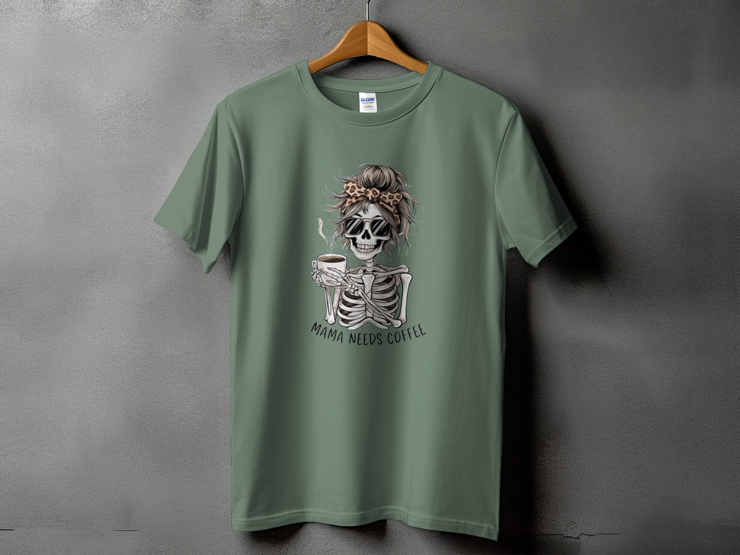 Green t-shirt with skeleton graphic holding coffee and text "MAMA NEEDS COFFEE".