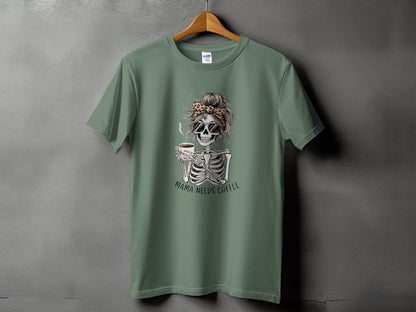 Green t-shirt with skeleton graphic holding coffee and text "MAMA NEEDS COFFEE".