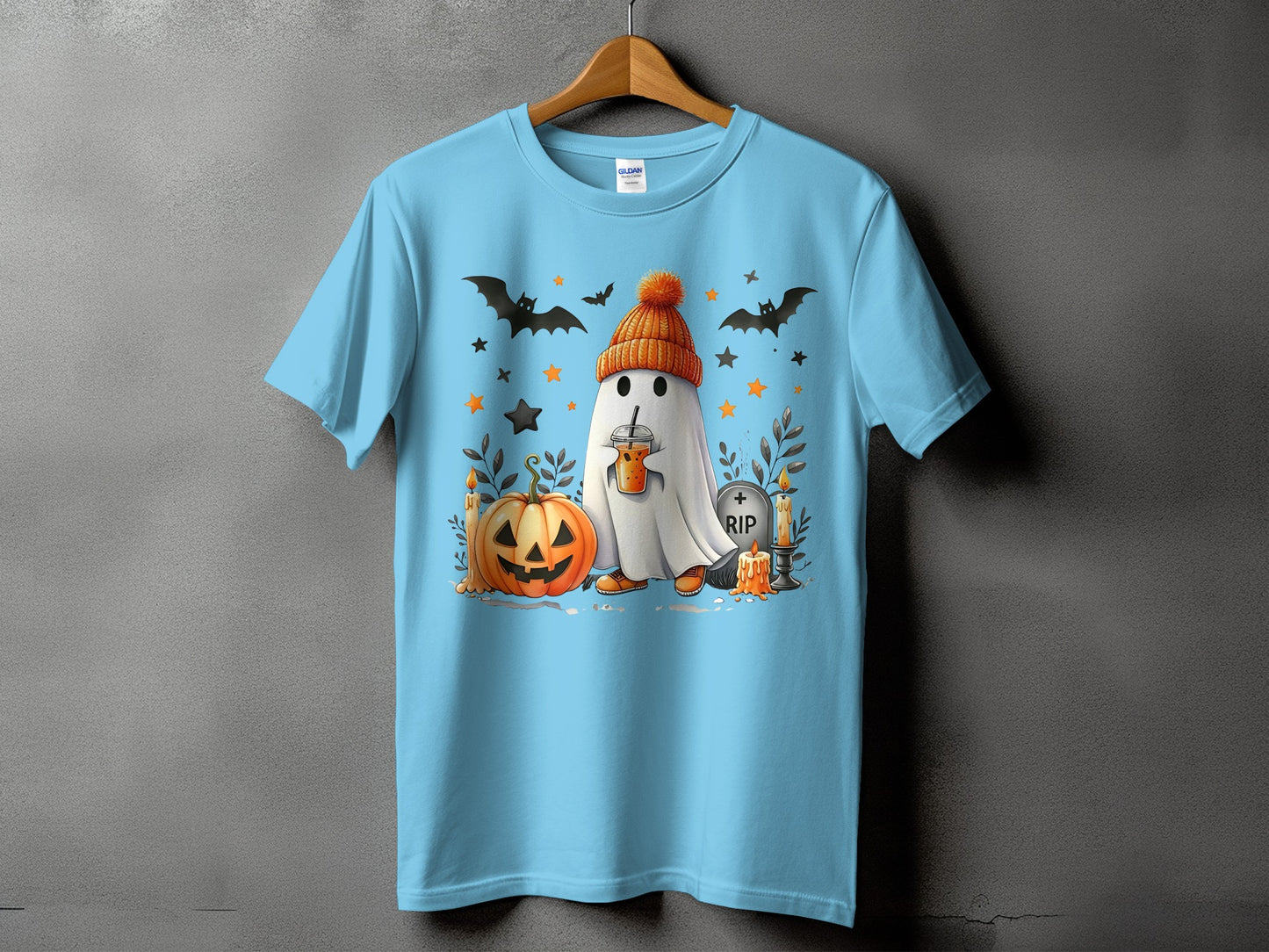 Light blue t-shirt with a Halloween ghost wearing an orange hat and drinking a latte.